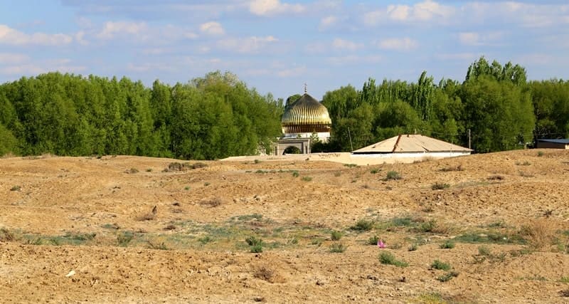 Medieval Sozak ancient settlement. In the distance – the dome of the Karabur mausoleum. 2024.