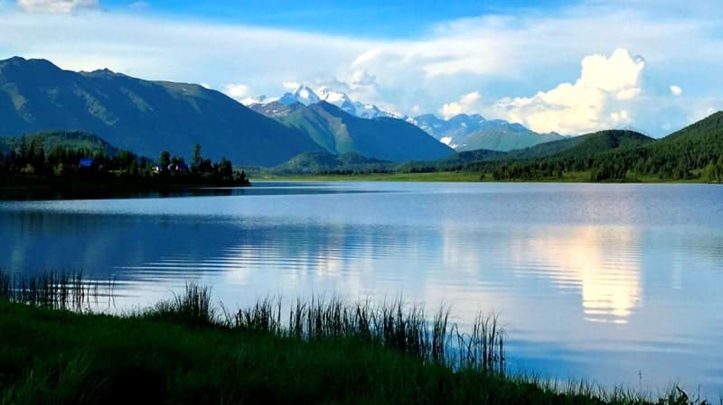 Mount Belukha (Muztau), located in the Katunsky Belok ridge against the background of Lake Yazevoy (Karakol). East Kazakhstan region.