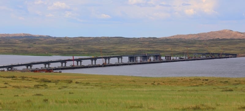 A bridge under construction across the Bukhtarma Reservoir in the East Kazakhstan Region. This is one of the largest road infrastructure projects in Kazakhstan in recent years. The bridge connects the two banks of the largest artificial reservoir. Its construction significantly reduced the distance between settlements.
