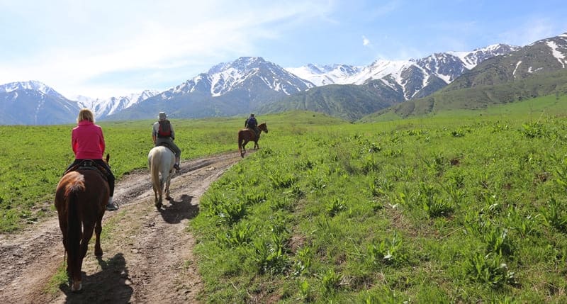 Tourists on horseback heading to Kshi-Kaindy Gorge.