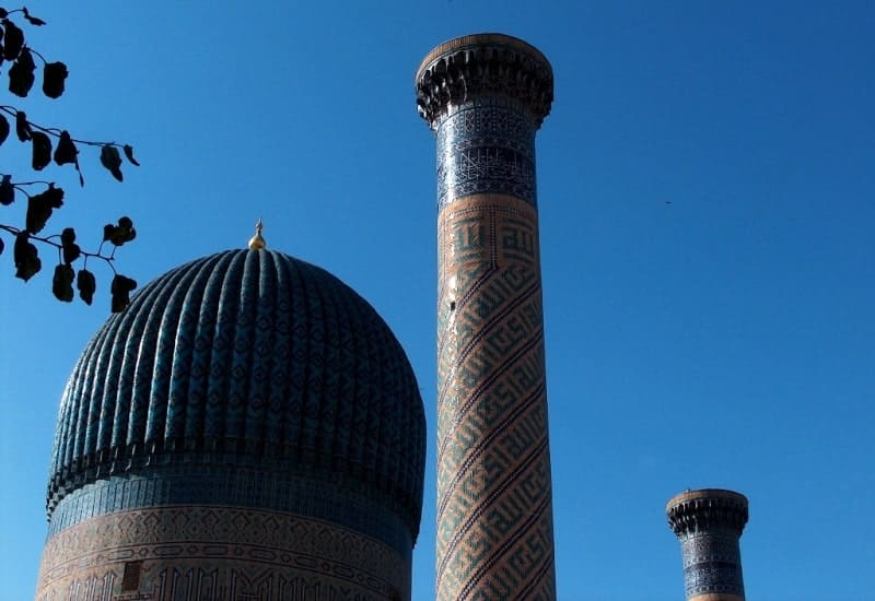 Two powerful, tall brick columns rise on either side of the dome.