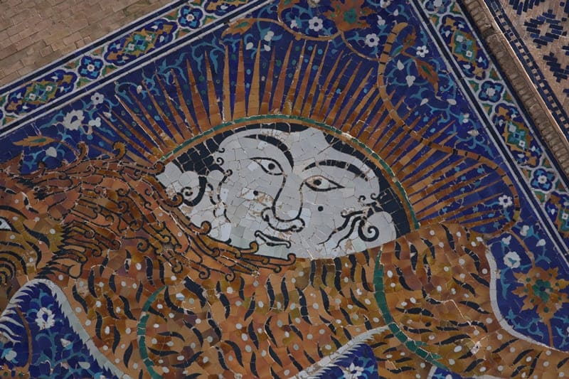 Particularly interesting is the filling of the tympanums of the portal arch with designs: a human face, a radiant oval sun, and the figure of a tiger pouncing on a deer.