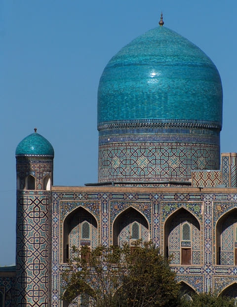 The dome of the Sherdor Madrasah is covered with glazed tiles of blue and light blue.