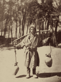 "Water Carrier." Photograph from the "Turkestan Album," created by order of Governor-General Konstantin von Kaufman. The photograph depicts a water carrier (sakka) from the city of Khujand (now Khujand, Tajikistan) in the Syrdarya region. The photograph was taken as part of an ethnographic study of Central Asia in the late 19th century, approximately 1871-1872.