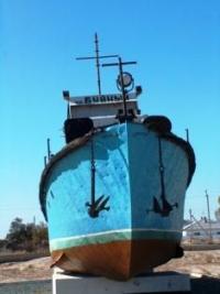 Monument to the ship "Buynyi" in the center of the village of Muynak.