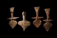 Amulets in the form of clay figures were put on a neck.