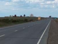 Road on share between settlements Dossor and Kulsary.